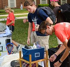 Students moving in to residence hall Photo of students moving in to residence hall