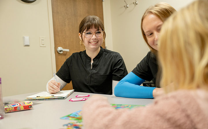 A student working with a boy in the BW Speech Clinic. 