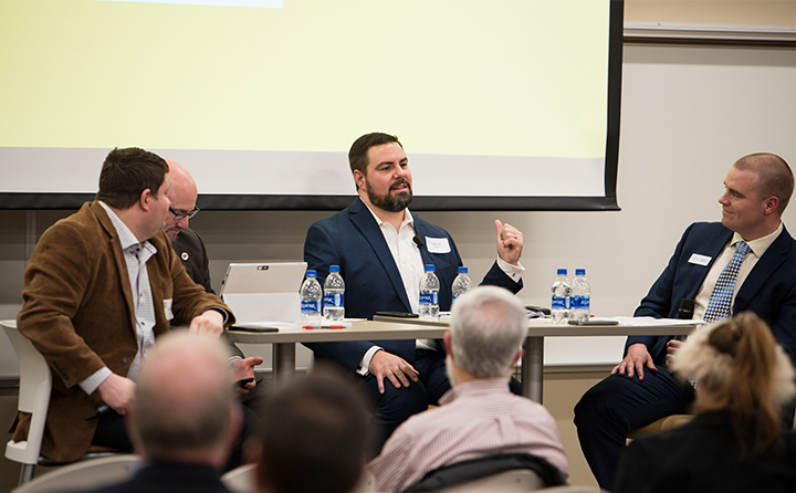 Photo of panel of people giving a lecture