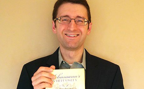 Alex Stefaniak '06 with his book, "Schumann's Virtuosity"