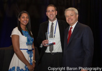 Arit Umana from Sherwin Williams (l) and NOCHE president Rob Briggs present the Expy award to Dr.Charles Campisi (center)