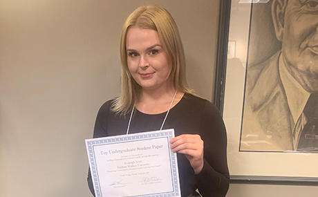 none Photo of evaliegh holding award for best paper
