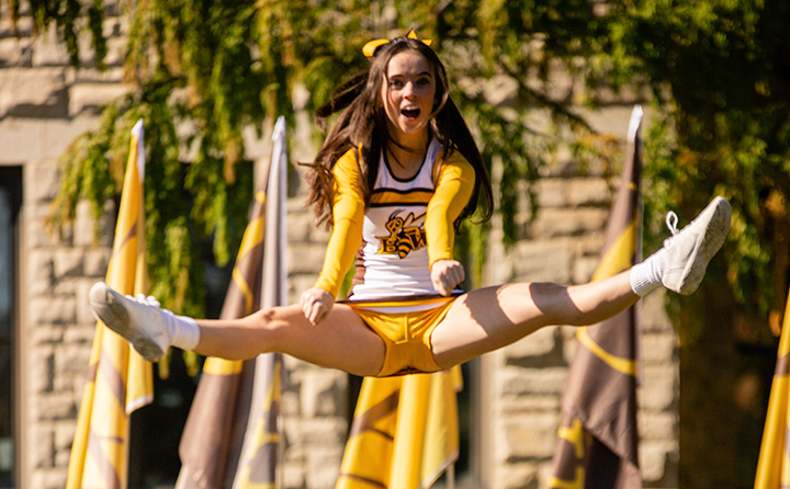 Yellow Jacket cheerleader leaps