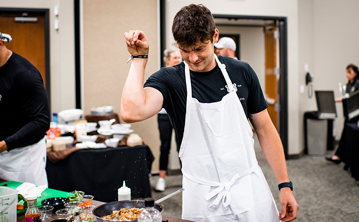 Browns kicker Cade York spices up his dish during the BW-hosted rookie cooking class.