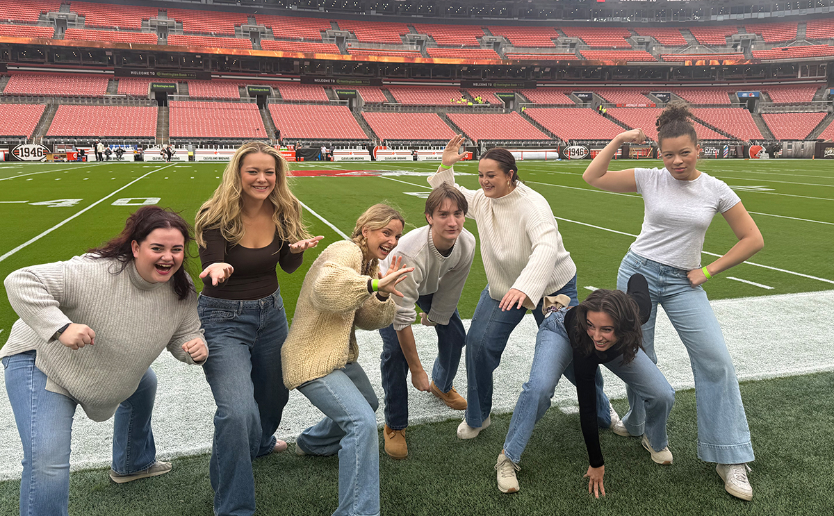 BW singers horsing around on the field before warming up