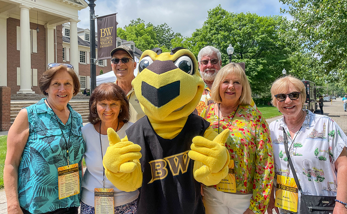 Alumni posing on campus