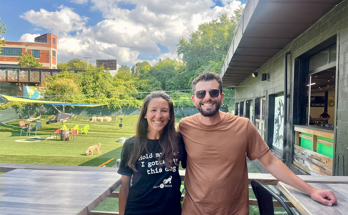 Eric Hollender, MBA '16 (right) with his wife and Taps & Tails co-founder Lisa.