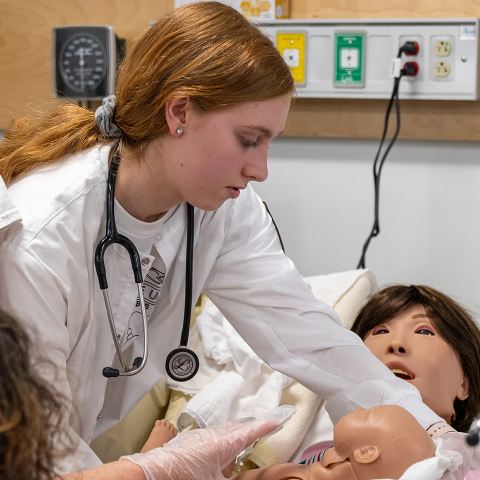 BW nursing student with birth simulator