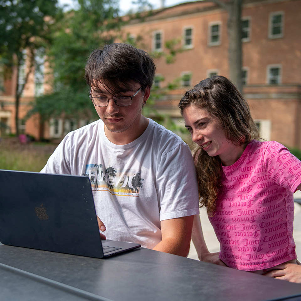 Students outside studying in North Quad.