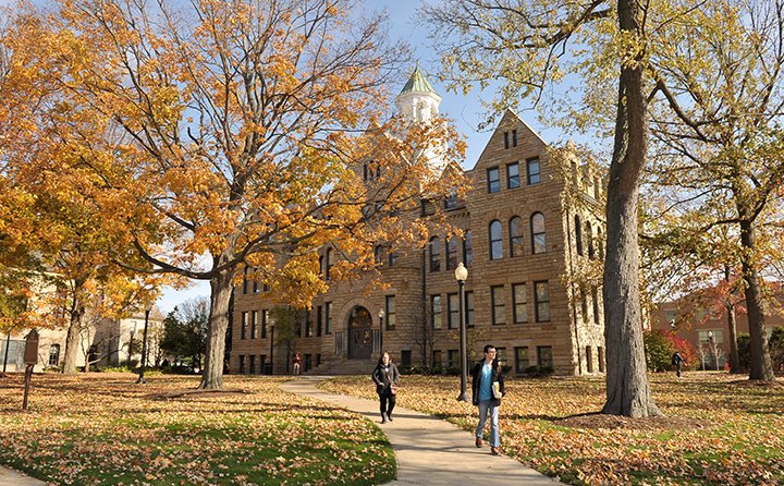 Students walk the historic BW campus in autumn. 