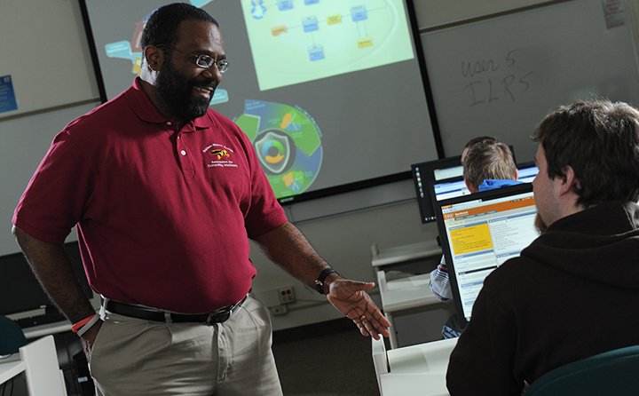 BW professor Kenneth Atchinson in a classroom with computer science students. 