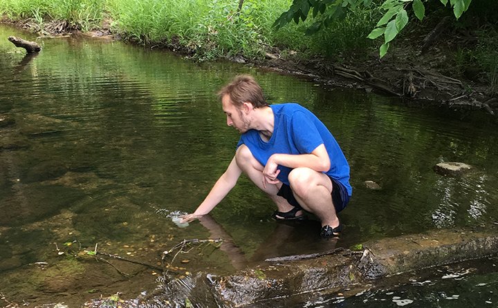 Tylor Mahany ’19 collects water quality samples from the east branch of the Rocky River. Tylor’s data will assist the Richfield Heritage Preserve with monitoring water quality. 