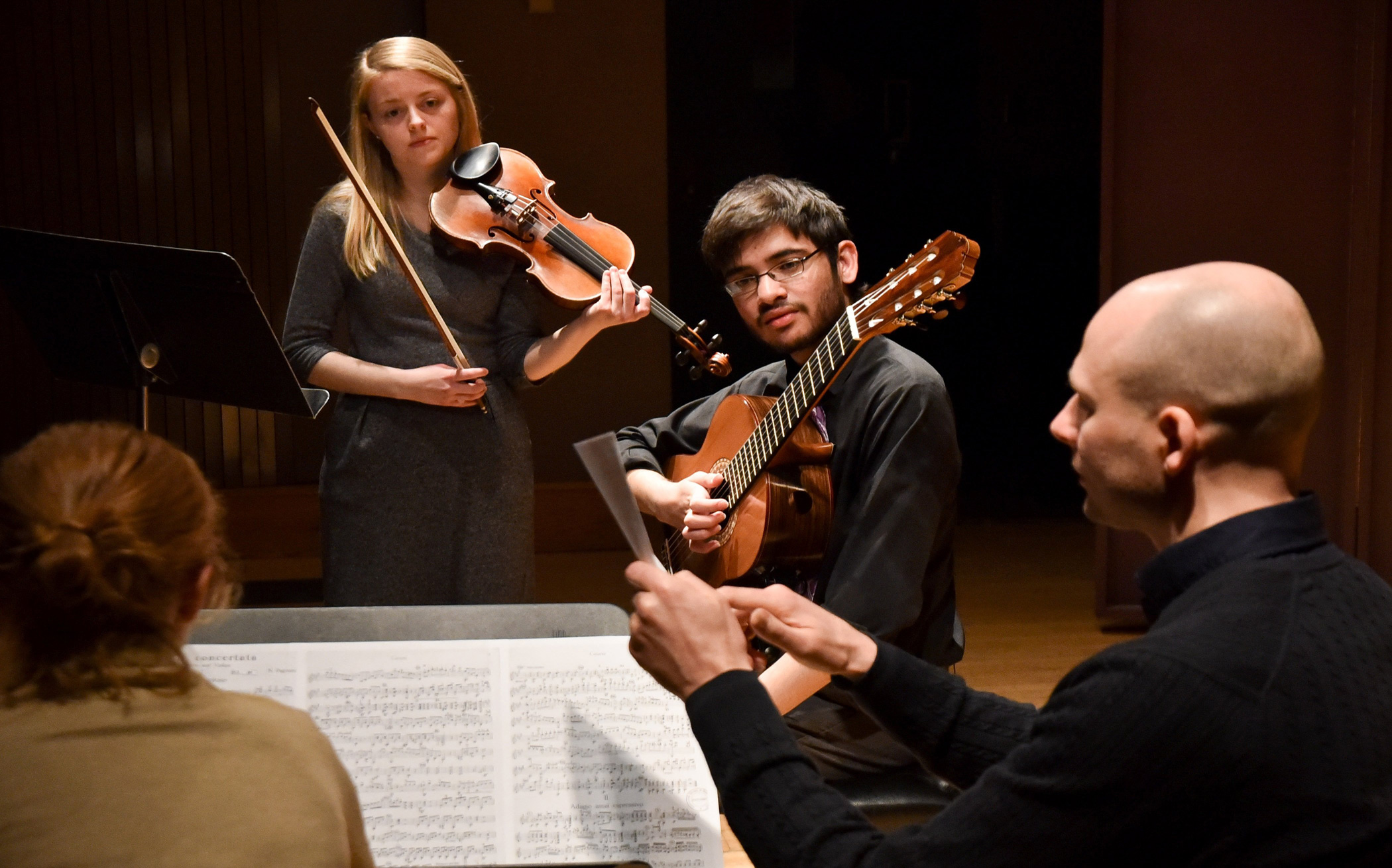 violinist and guitarist engaging in music discussion