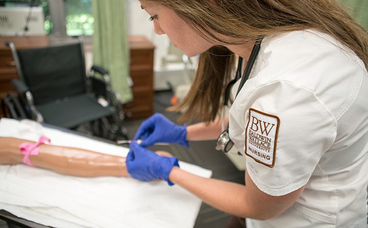 BW Nursing student practices procedures on a dummy