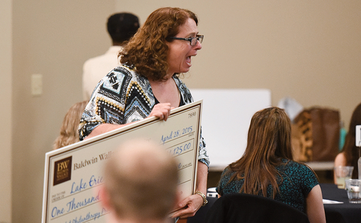 Photo of woman receiving award check