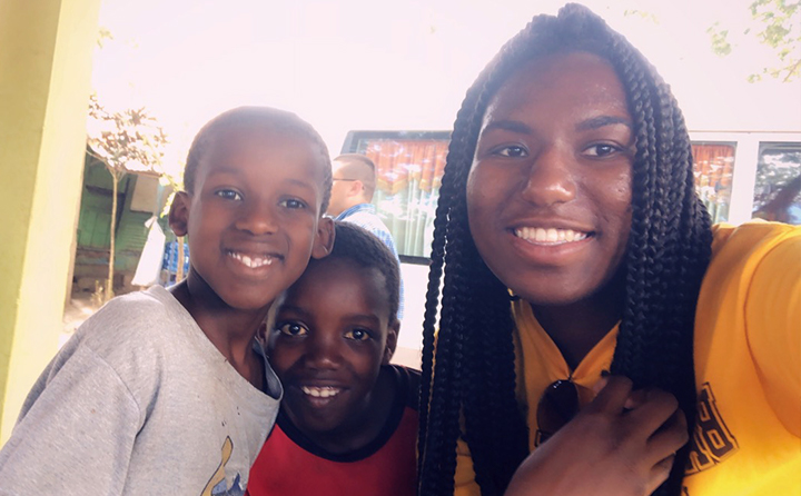 BW student Autumn Richards (right) with two children in the Dominican Republic on an Honors Program trip