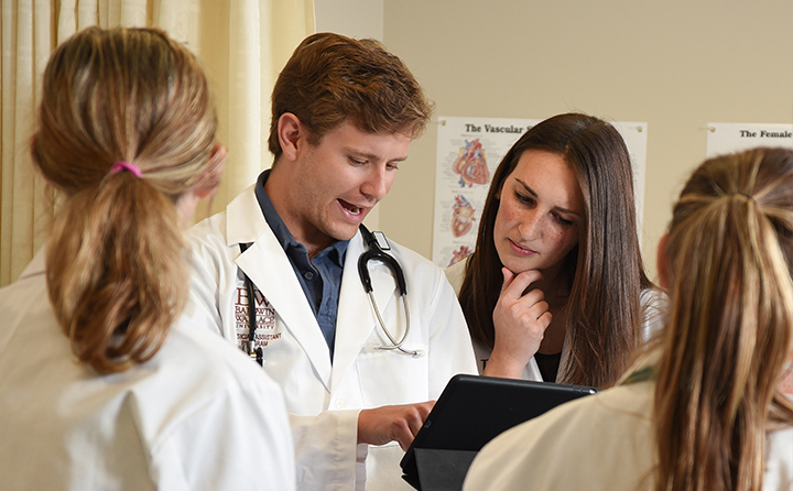 Students looking over a medical chart