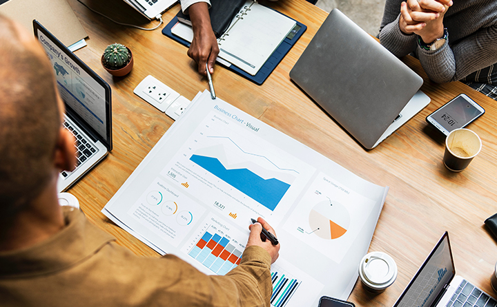 Photo of people examining a business chart