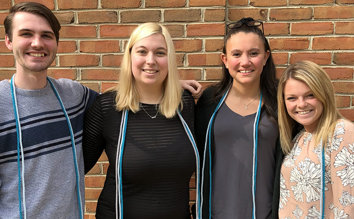 Photo of students with graduation cords