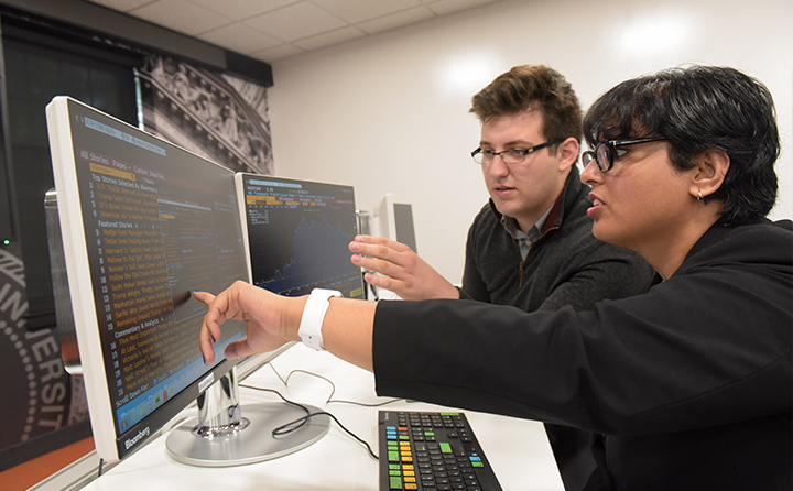 Photo of a student and a professor at a computer