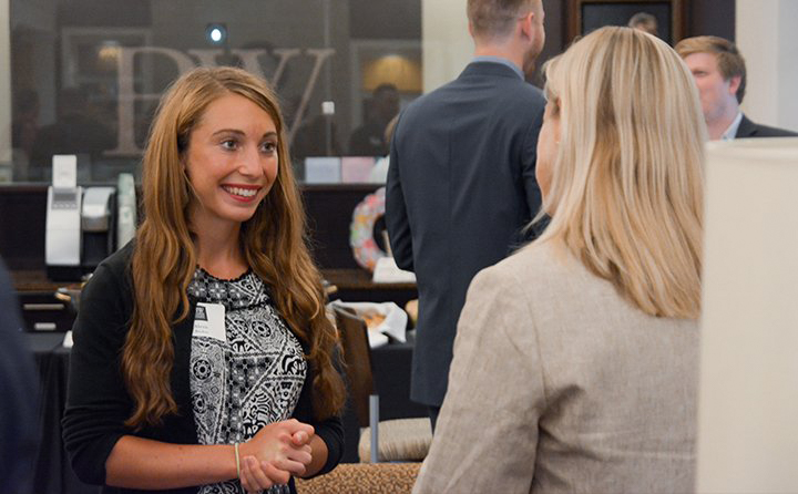 Photo of two women talking at an event