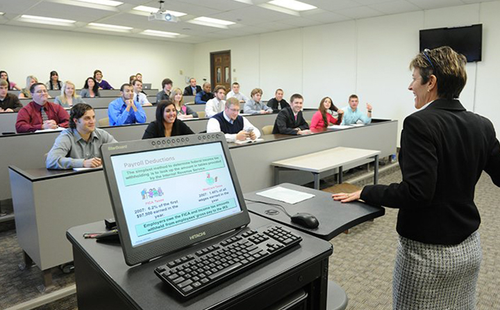 Photo of professor in front of students at a lecture