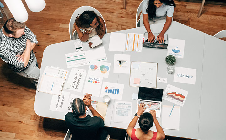 Professionals sitting around table strategic marketing