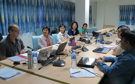 Baldwin Wallace University public health professor, Ubydul Haque, Ph.D. (left), meets with members of his Thailand-based research team.