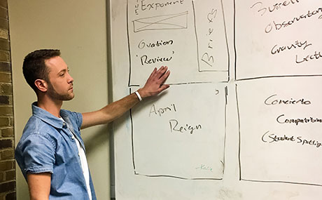 Exponent executive editor Drew Boxler maps out a front page storyboard for The Exponent.