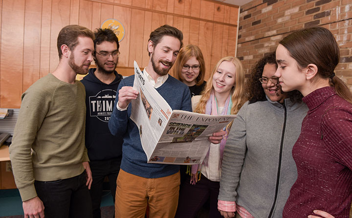 Members of the 2017-18 Exponent staff gather around new faculty advisor Dr. Brandon Szuminsky