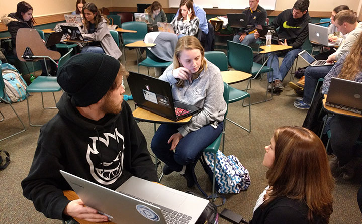 Dr. Lauren Copeland and students review survey numbers