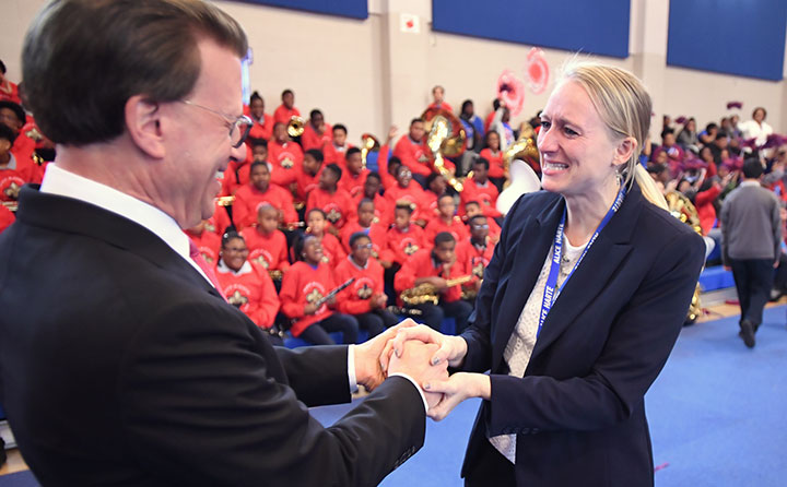 Milken Family Foundation Chairman and Co-Founder Lowell Milken greets a tearful Theresa Cross. Photo courtesy: Milken Family Foundation