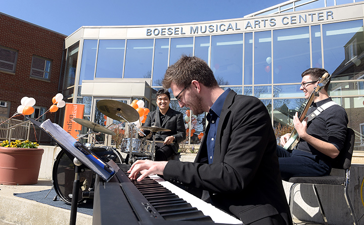 Photo from Ovation 2018 of three men performing outside Boesel