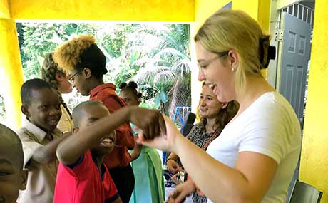 Photo of Emma Anderson dancing with children in Jamaica