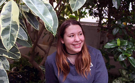 Tessa Fenstermaker (seen here in BW's biology greenhouse) conducted undergraduate research projects in both biology and German.