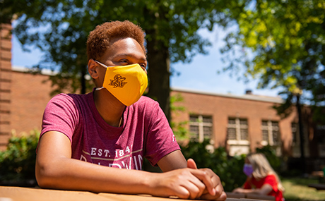 Student in mask on campus
