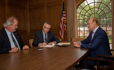 BW Provost Steve Stahl (left), President Bob Helmer (center) and CM Law Dean Lee Fisher (right) sign the new 3+3 agreement.