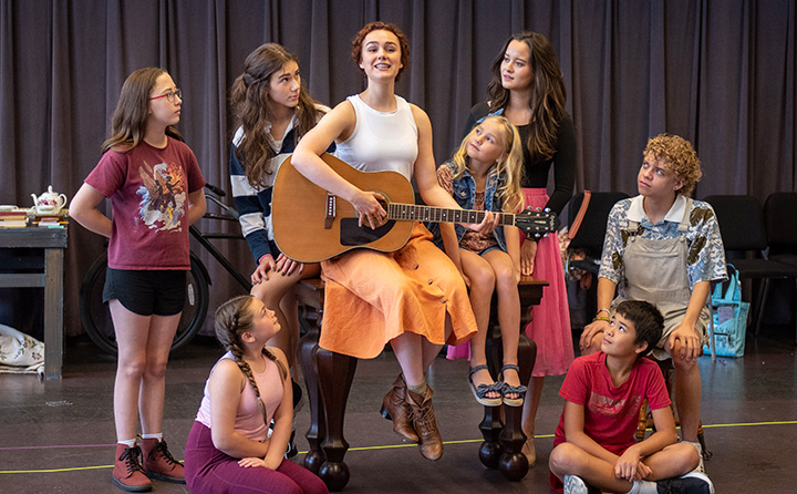Cast members for The Sound of Music, with Lauren Senden '23 (center) playing Maria , rehearse Do-Re-Mi