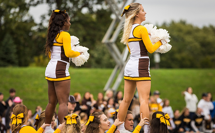 Yellow Jacket cheerleaders on the sidelines.