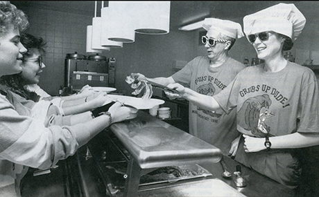 Then-deans Mark Collier (left) and Frances Lucas (right) serving students at the third annual Midnight Breakfast in 1990. 