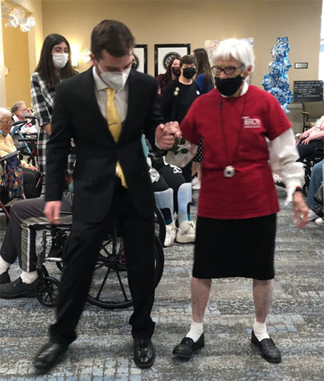 Flo Ebal, right, gives BW Rotaract Club member Jake Dunstan ’23 some basic dance lessons during the Snow Ball at Generations Senior Living Berea. (Photo by Linda G. Kramer)