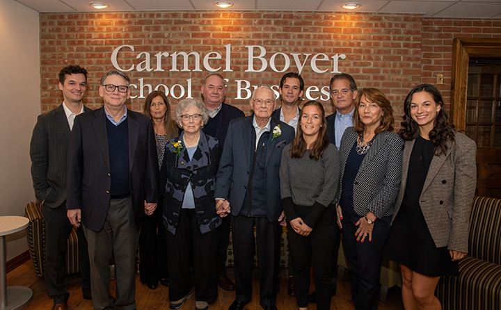 Carmel, (center wearing corsage) surrounded by members of his family at the April 29 event to celebrating the naming of the BW Carmel Boyer School of Business.