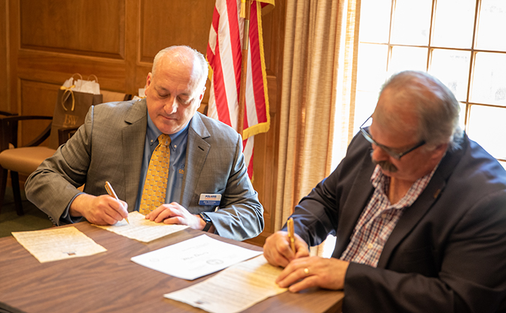 Polaris Superintendent Robert Timmons (left) and BW Provost Stephen Stahl (right) sign the articulation agreement.