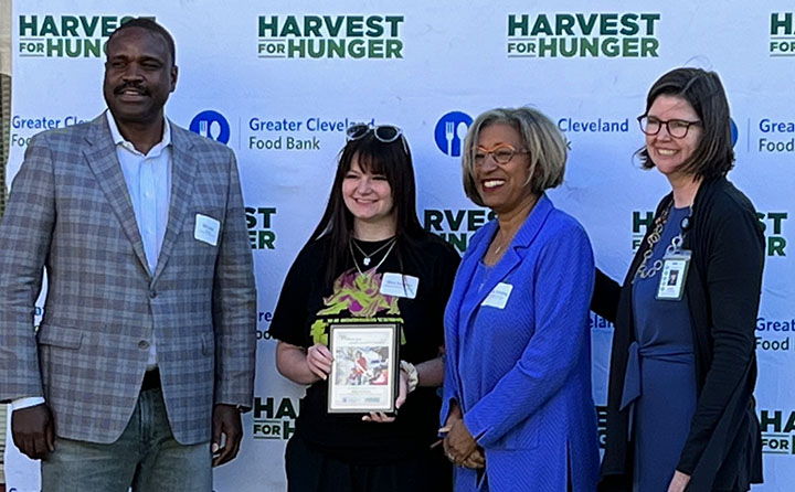 Nina Bauman '22 (second from left) poses with her award and officials at the June Harvest for Hunger Campaign Recognition Ceremony.
