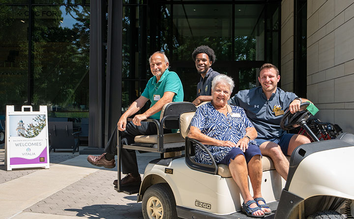 Vitalia residents and their BW guides head out for a golf cart tour of campus.