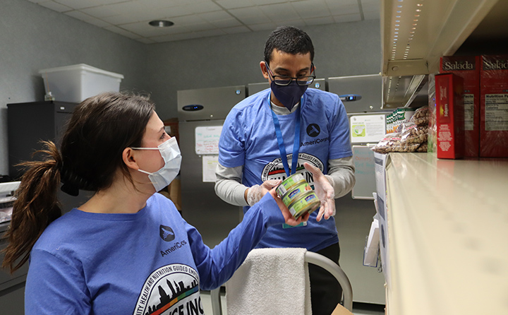 BW AmeriCorps volunteers Madi Clymire ’23 a BW biology major, and Adit Mahesh, a community volunteer, stock the food pantry at MetroHealth’s Food as Medicine Clinic