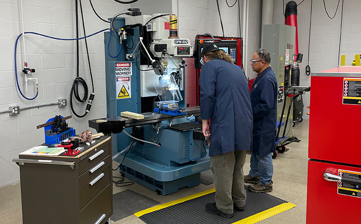Early in the sensor research project, Mlady (left) and BW engineering lab technician, Martin Flores, use the CNC Mill in BW’s Fabrication Laboratory to create parts for a prototype sensor enclosure. 