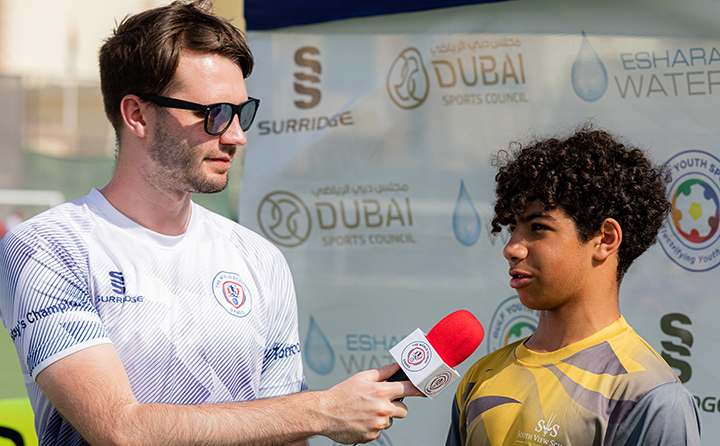 Holden Daly interviews young athlete in Dubai