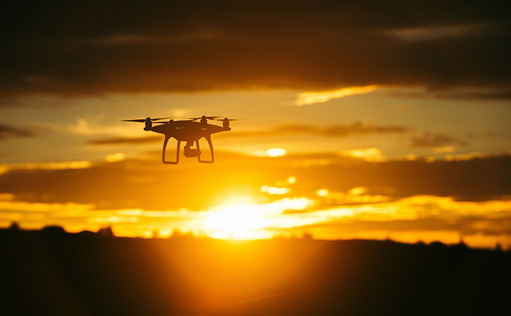 Drone in flight at sunset