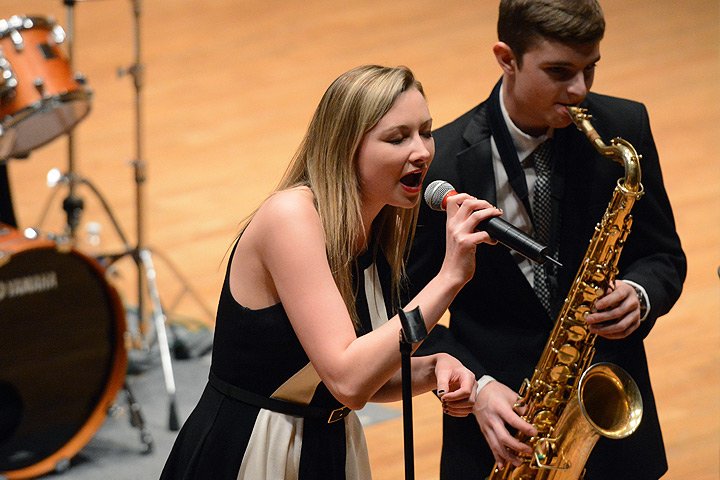 Female student singing into microphone